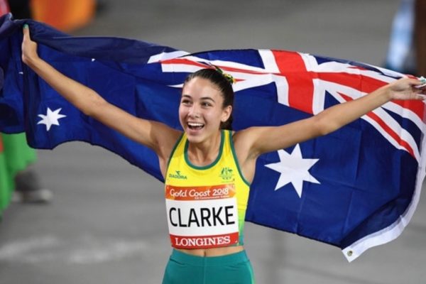 Paralympian Rhiannon Clarke, smiling with Australian Flag